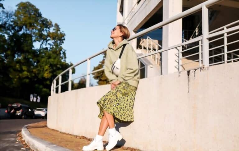 a girl with a hoodie combined with a baby patterned skirt and white boots a girl with a hoodie combined with a baby patterned skirt and white boots