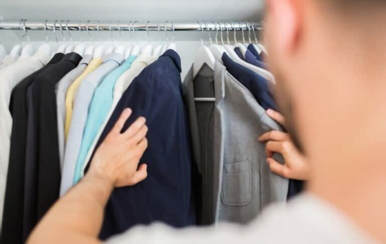 man choosing clothes carefully