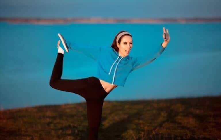 a girl with blue short sweater and black leggings practices exercise