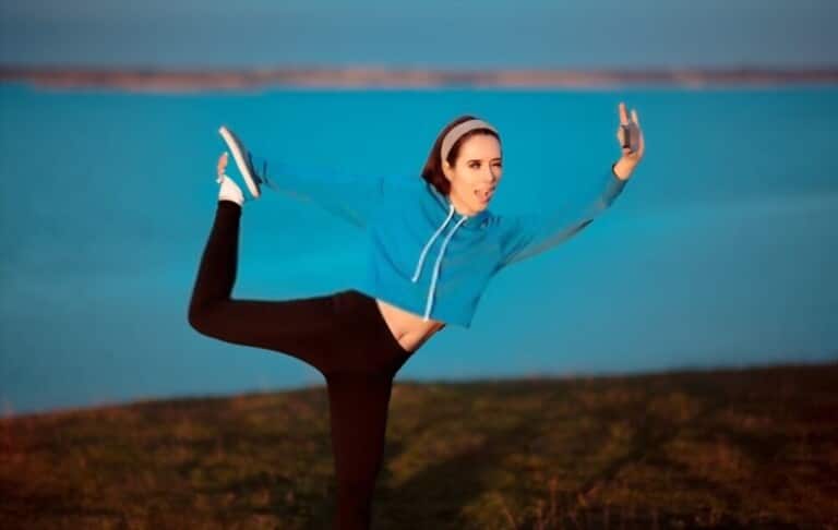 a girl with blue short sweater and black leggings practices exercise a girl with blue short sweater and black leggings practices exercise