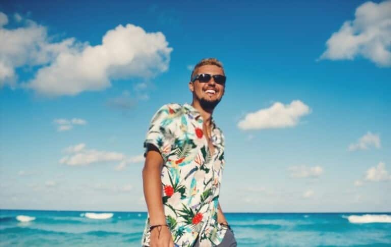 a man with Hawaiian shirt on the beach