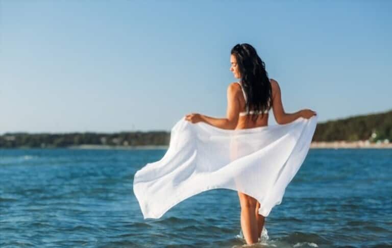 an attractive women wearing bikini and beach wraps on beach concept