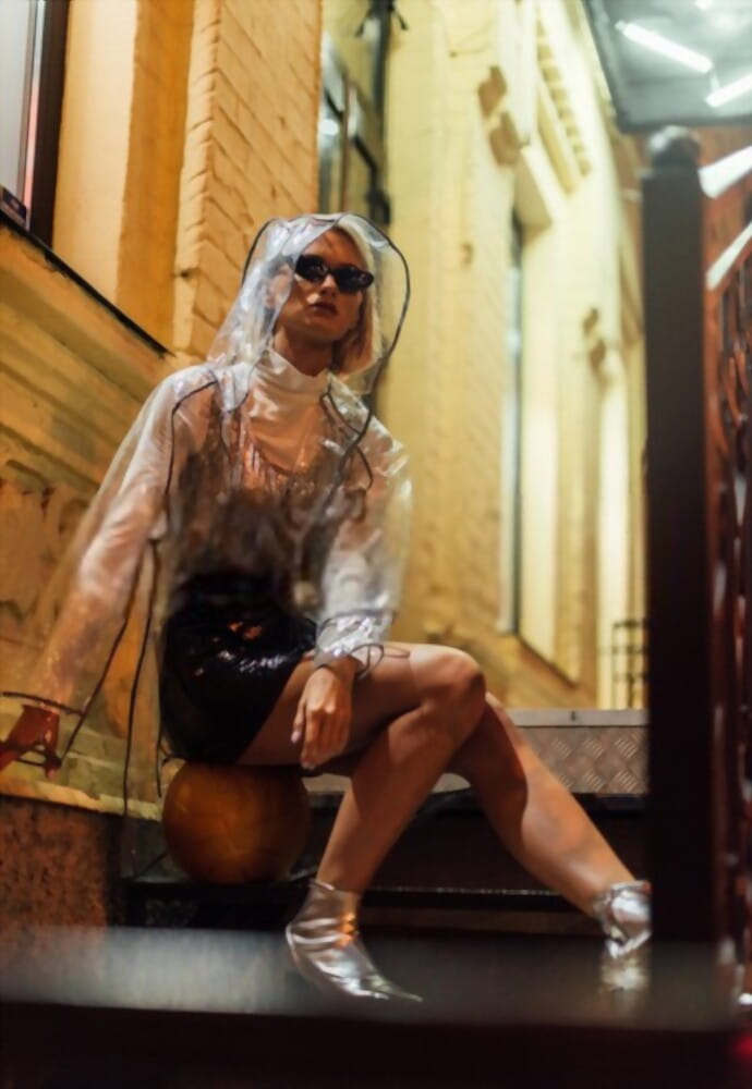 woman with high fashion clothes with transparent raincoat