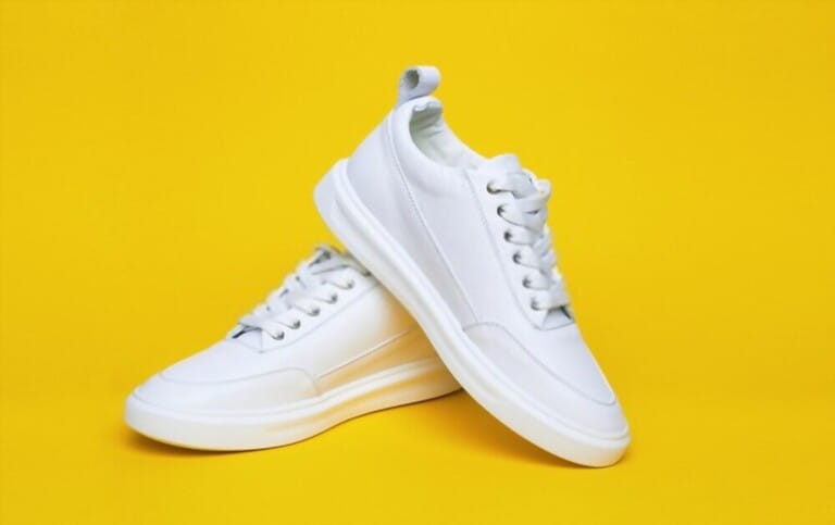 White Sneaker on yellow background White Sneaker on yellow background
