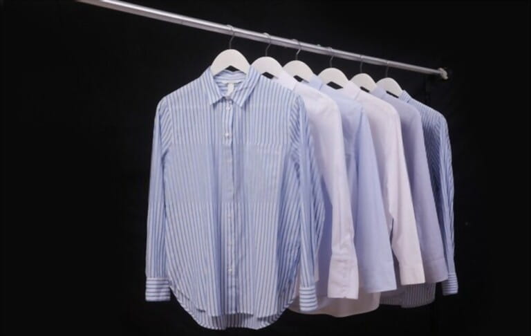 long sleeved blue and striped shirts ,blue on hanger-black background