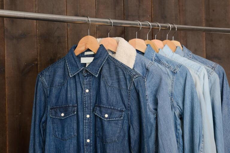denim shirts on hanger-wooden background denim shirts on hanger-wooden background
