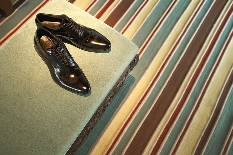 Oxford shoes placed on a fur chair taken close-up Oxford shoes placed on a fur chair taken close-up