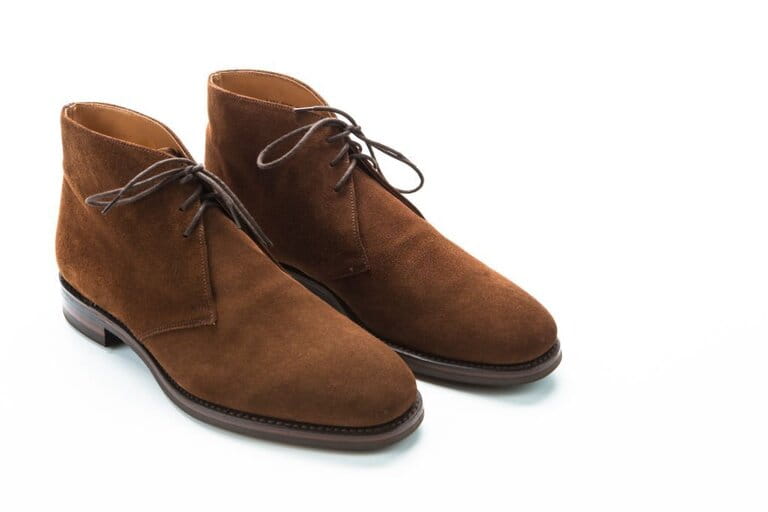 Men's shoe ideas. Close-up of men's brown Chukka suede suede shoes on a white background. Horizontal photo