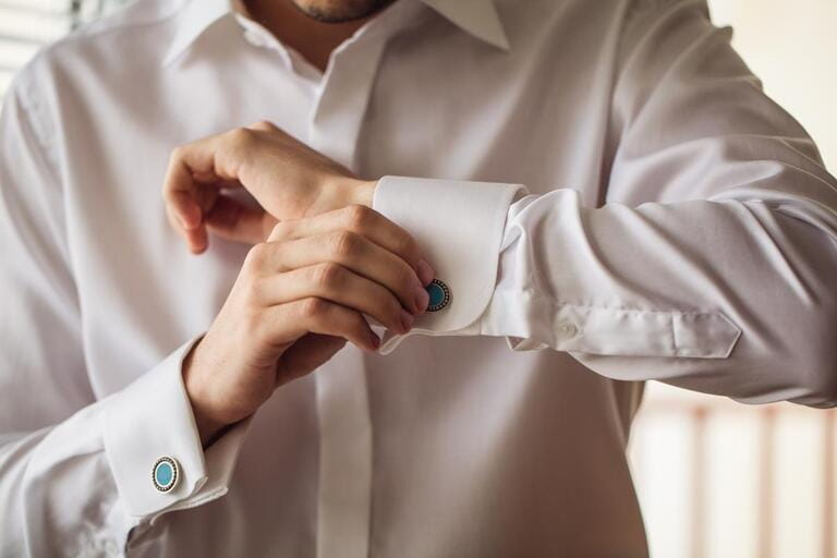 The man in the white shirt in the window dress cufflinks. The man in the white shirt in the window dress cufflinks.