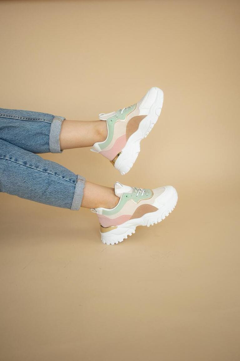 Product photography: colorful women's sneakers on beige background.