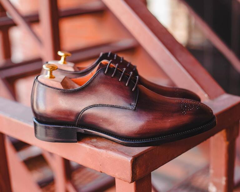 Classic man leather derby shoes with industrial background