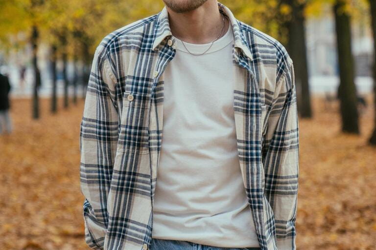 torso of man wearing flannel in autumn