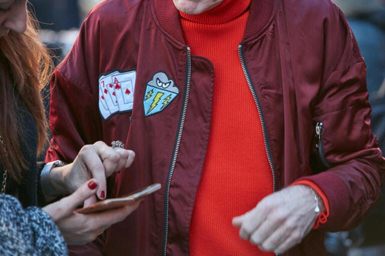 Man with dark red bomber jacket and red sweater before Etro fashion show, Milan Fashion Week street style 