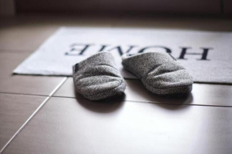 Slippers on a carpet at the entrance with shallow depth of field