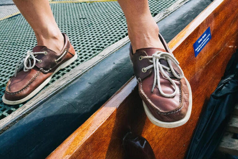 Boat shoes of our punting tour guide and professional punter in the pier in Cambridge, UK