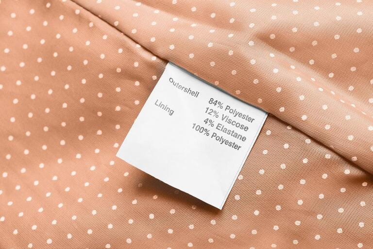 Fabric composition clothes label on beige textile background
