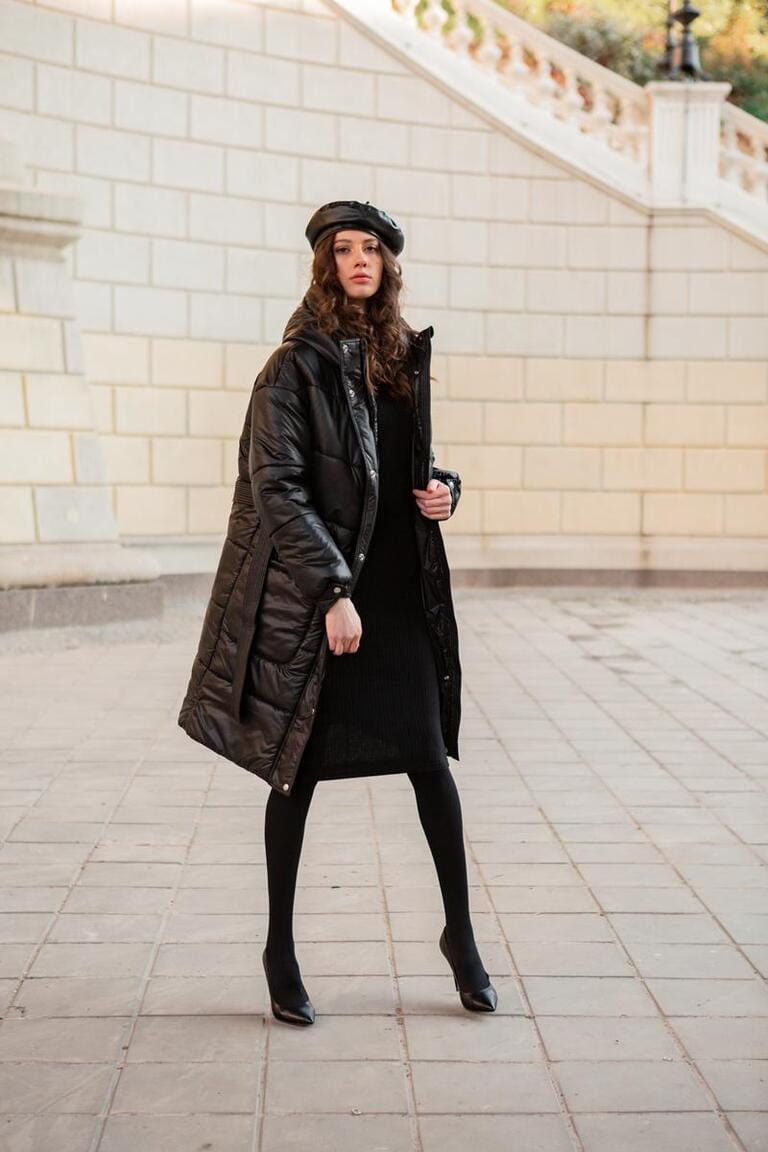 stylish woman posing in winter autumn fashion trend black puffer coat and leather hat beret in old beautiful street wearing high heel shoes stylish woman posing in winter autumn fashion trend black puffer coat and leather hat beret in old beautiful street wearing high heel shoes