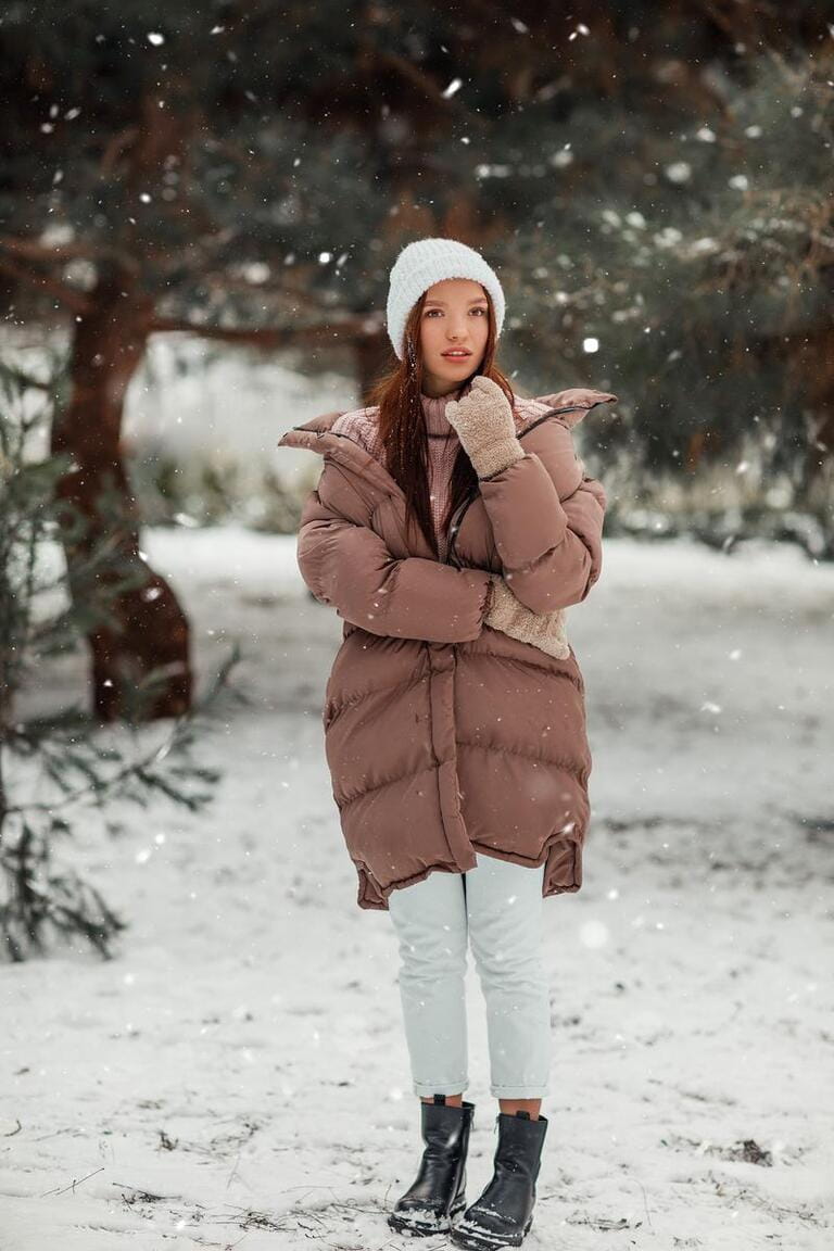 A young young girl in a snowy forest