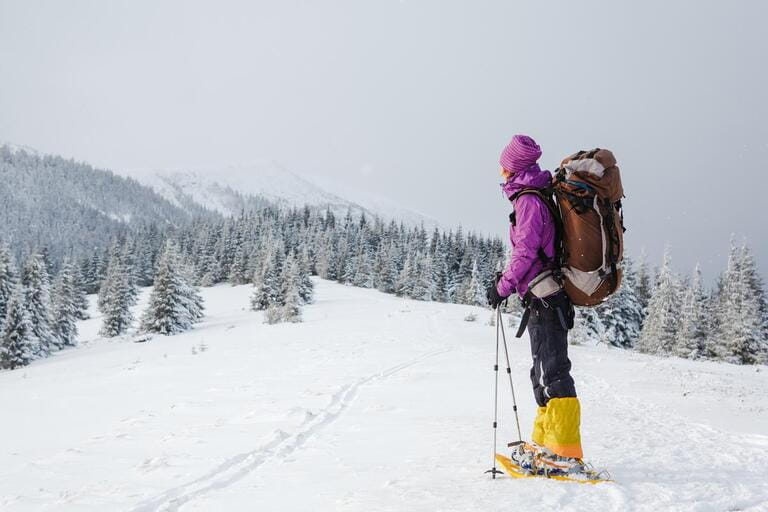 Hiker in winter mountains snowshoeing Hiker in winter mountains snowshoeing