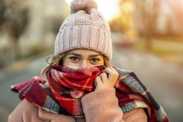 Beautiful young woman feeling cold in winter