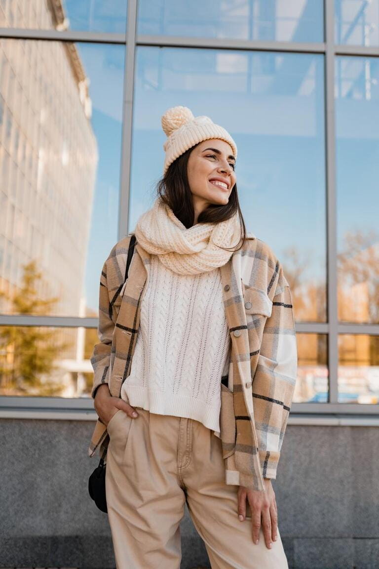 stylish attractive young smiling woman walking in street in winter outfit with coffee wearing checkered coat, white knitted hat and scarf, happy mood, fashion style trend stylish attractive young smiling woman walking in street in winter outfit with coffee wearing checkered coat, white knitted hat and scarf, happy mood, fashion style trend