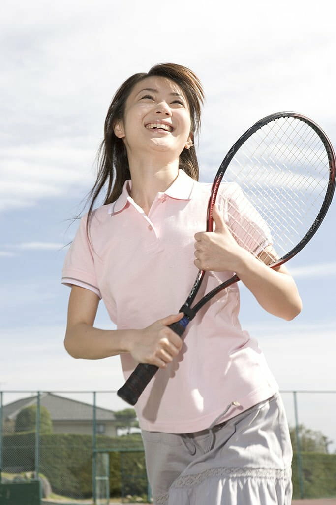 Young woman holding a tennis racquet Young woman holding a tennis racquet