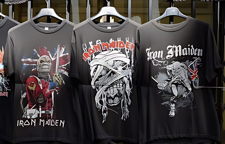 ATHENS, GREECE - APRIL 1, 2018: T-shirts printed with designs by heavy metal band Iron Maiden. Vintage rock music memorabilia for sale.