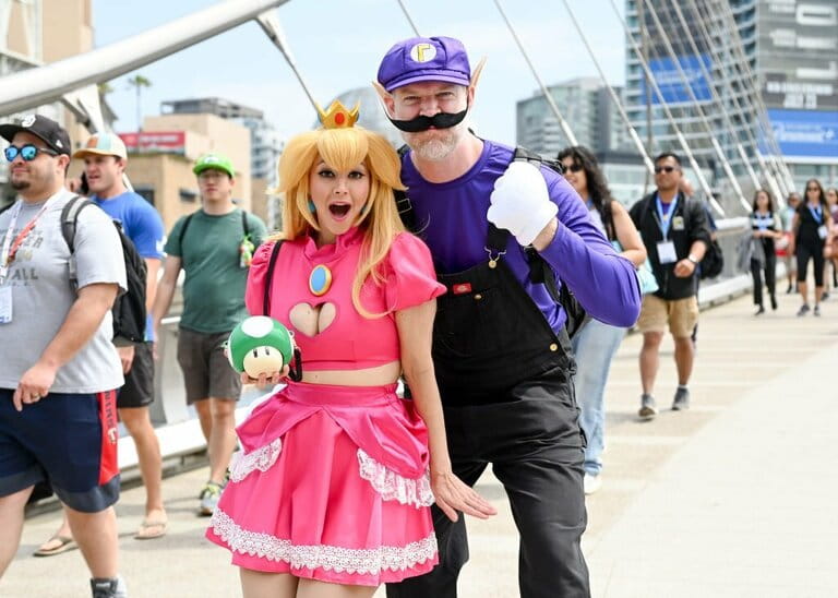 Cosplayers dressed as Princess Peach and Waluigi from "Super Mario Bros" at the 2023 Comic