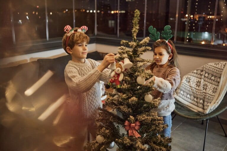 Happy children decorate the Christmas tree Happy children decorate the Christmas tree