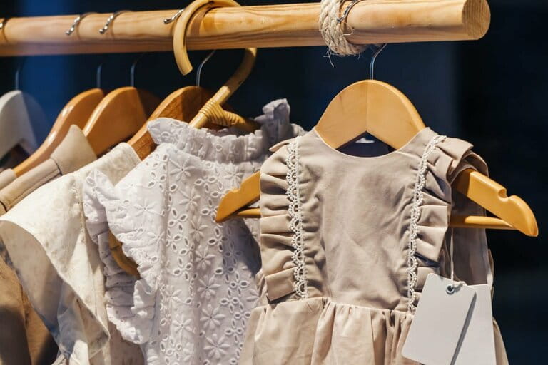 Children wear clothes in the store on hangers. Tailoring for the youngest