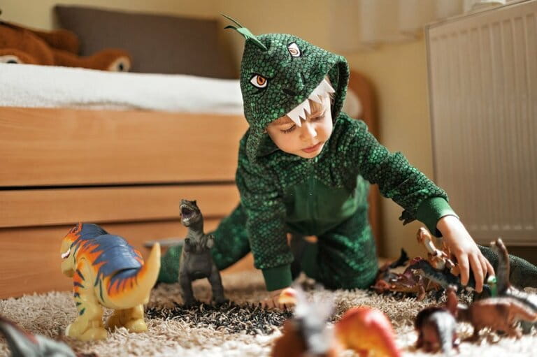 Adorable boy playing with his dinosaur