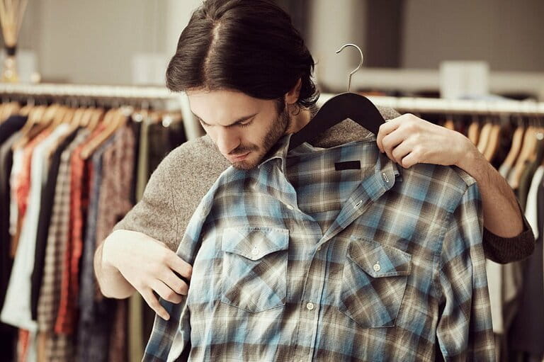 Man choosing clothes in store