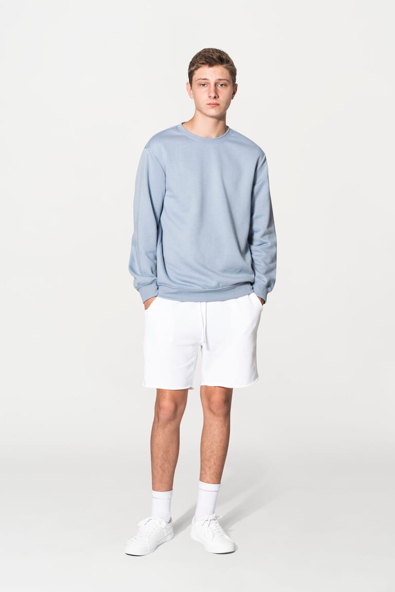 Teenage boy in blue sweater apparel studio portrait