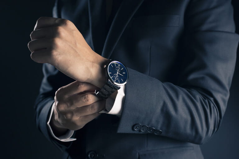Businessman checking time from watch Businessman checking time from watch