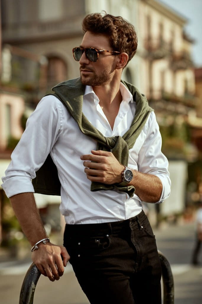 Stylish man wearing sunglasses and white shirt. City life