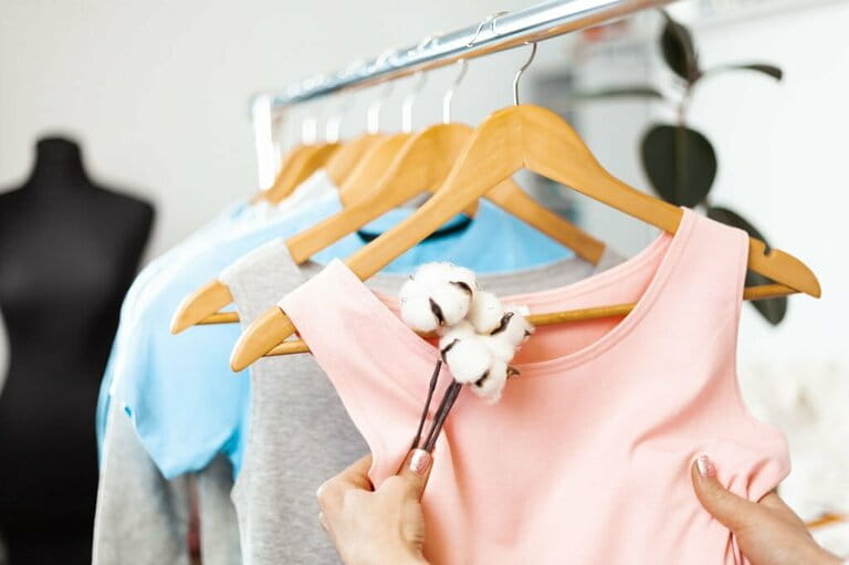 Organic cotton clothes. Hangers with dresses in the store. Sustainable fashion, caring for the environment