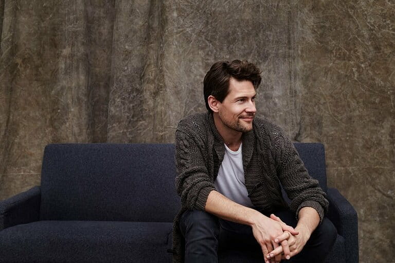 Model smiling on sofa Model smiling on sofa