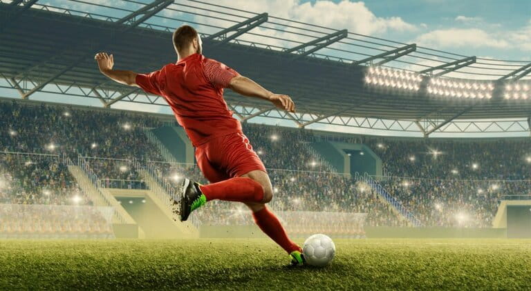 Soccer player kicks a ball Soccer player kicks a ball