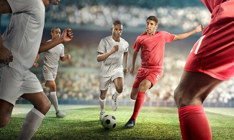 Soccer player kicks the ball in the stadium Soccer player kicks the ball in the stadium