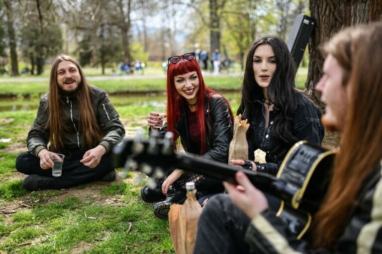 Happy Gothic Friends Enjoying Drinking In Park With Guitar Music Happy Gothic Friends Enjoying Drinking In Park With Guitar Music