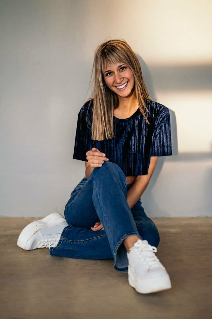 Young blond woman sitting on the ground at home Young blond woman sitting on the ground at home