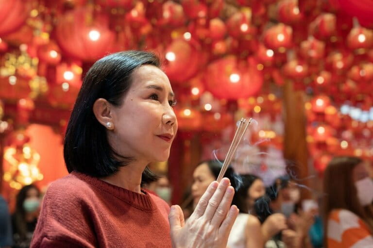 Asian family praying to Buddha on Lunar New Year Asian family praying to Buddha on Lunar New Year