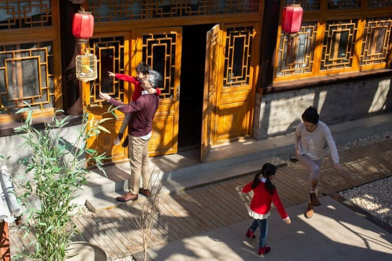 Happy Chinese family having fun in yard Happy Chinese family having fun in yard