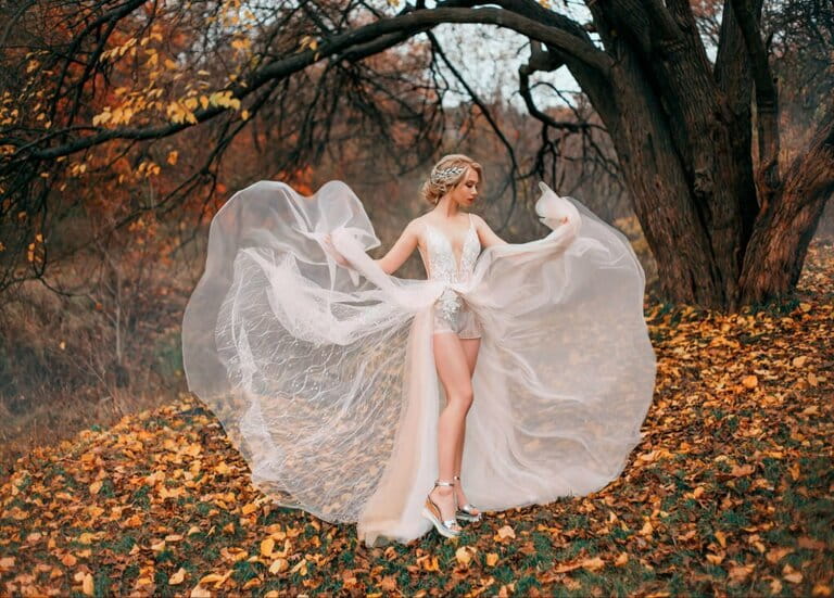 Beautiful young woman dancing against a backdrop of yellow autumn leaves. The fairy princess enjoys the natural forest. Sexy transparent white dress flying in the wind showing off her long legs. Classic blonde Beautiful young woman dancing against a backdrop of yellow autumn leaves. The fairy princess enjoys the natural forest. Sexy transparent white dress flying in the wind showing off her long legs. Classic blonde