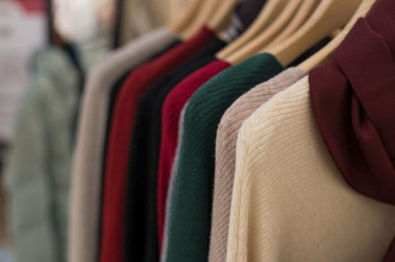 Warm winter women knit fabric on hangers in a clothing store. Warm winter women knit fabric on hangers in a clothing store.