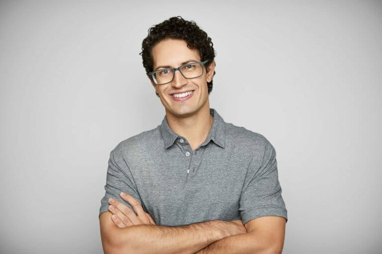 Smiling Young Man Against White Background Smiling Young Man Against White Background