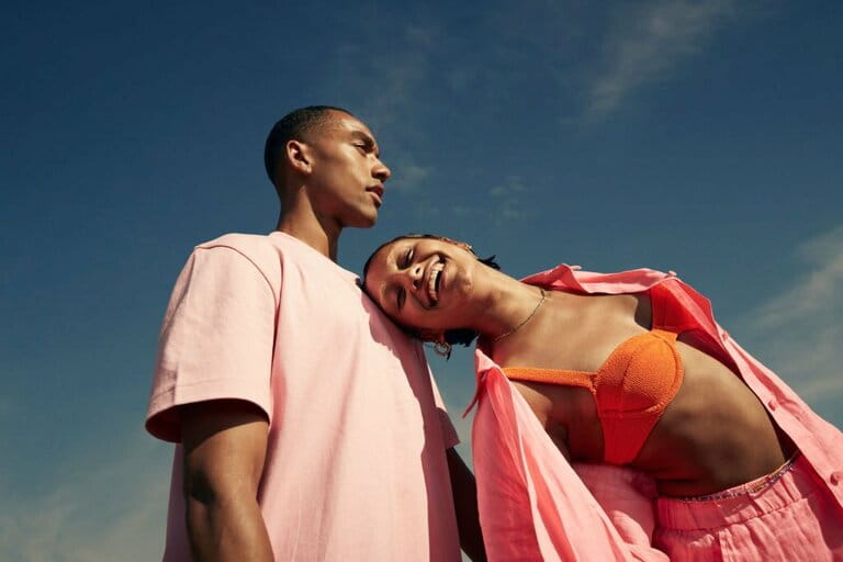 Smiling woman leaning on man against sky Smiling woman leaning on man against sky