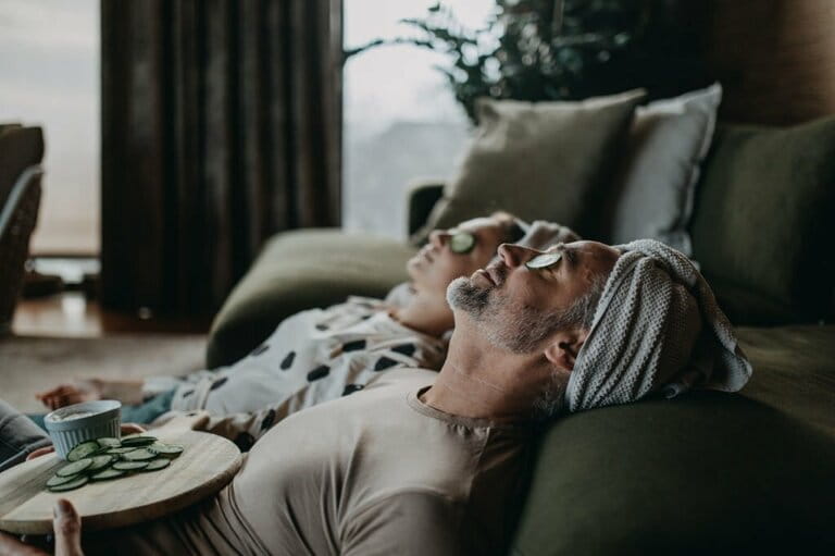 Father and teen daughter applying face mask together at home. Father and teen daughter applying face mask together at home.