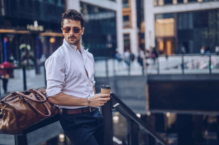Stylish young businessman has coffee to go
