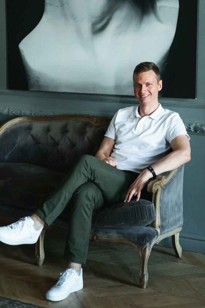 Handsome man beautifully dressed in white shirt in interior